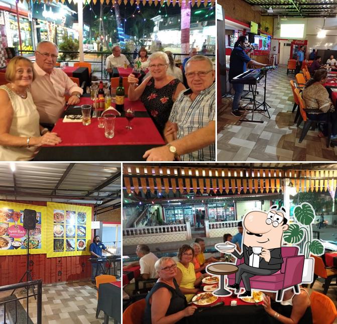 Take a seat at one of the tables at Spice rack, bar n restaurant