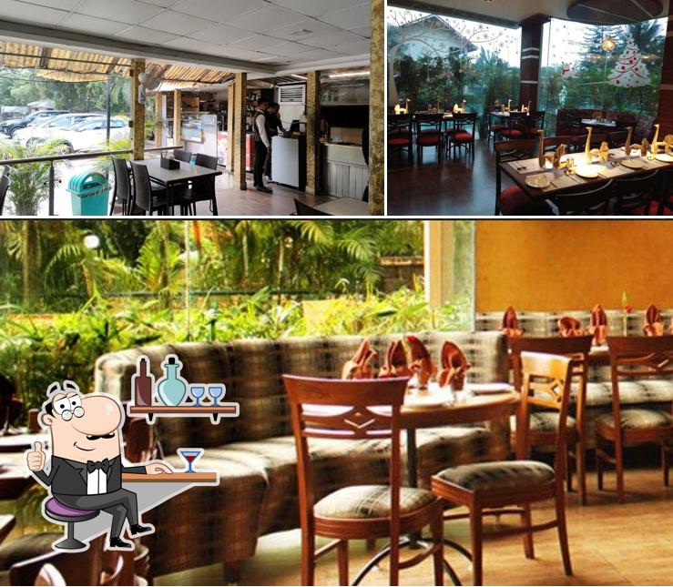 Take a seat at one of the tables at Rudra Restaurant - Kailash Parbat Hotel
