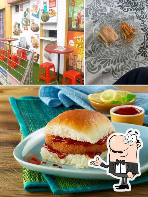 Check out the image displaying interior and food at Goli Vada Pav No. 1