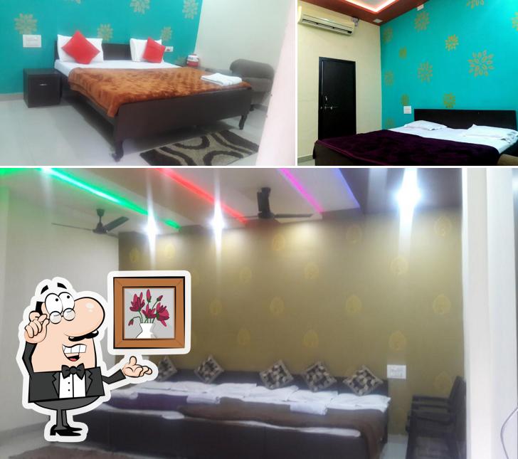 Take a seat at one of the tables at Hotel Ganesh And Restaurent
