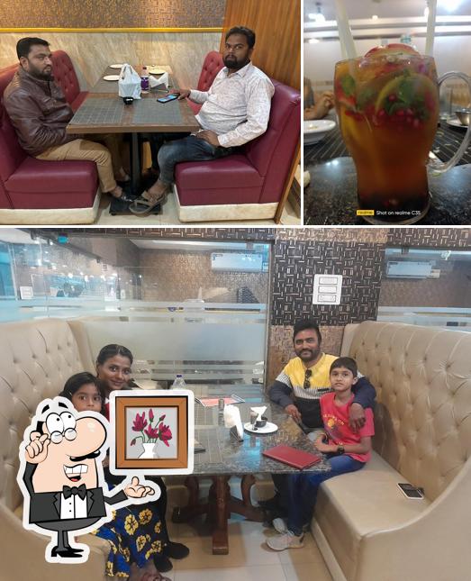 Check out the photo showing interior and food at Paradise House Multicuisine Restaurant