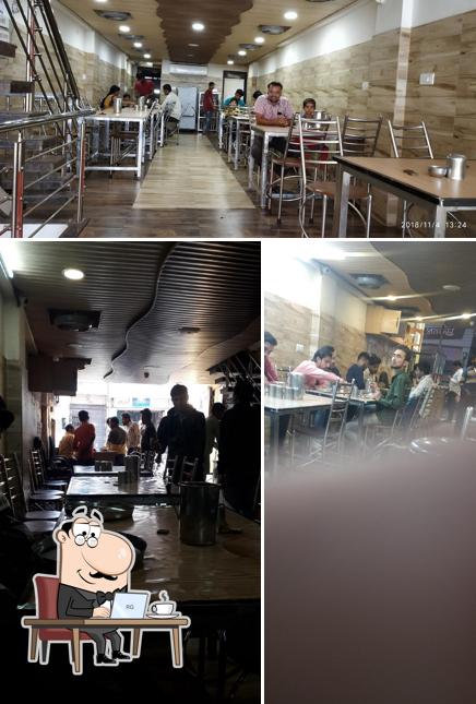 Take a seat at one of the tables at श्री राम कृपा दाल बाटी भण्डार