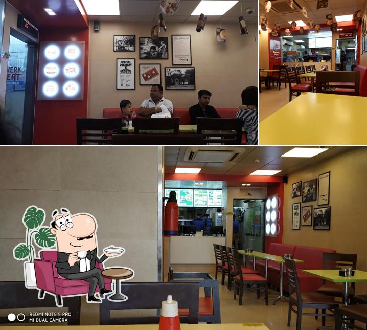 Take a seat at one of the tables at Domino's Pizza Laxmisagar, Bhubaneswar