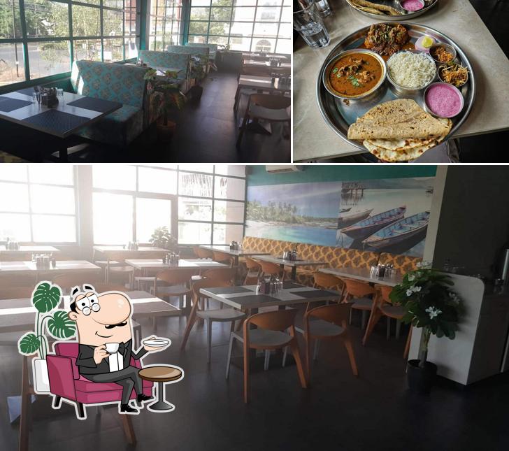Check out the image depicting interior and food at Malvan Seafood Restaurant