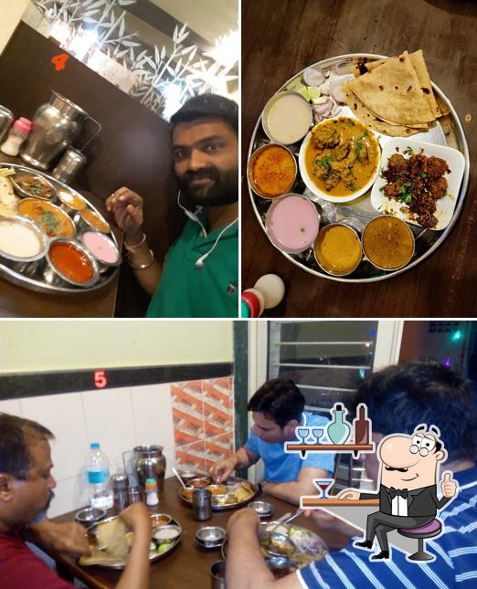 Take a seat at one of the tables at Hotel Nilesh