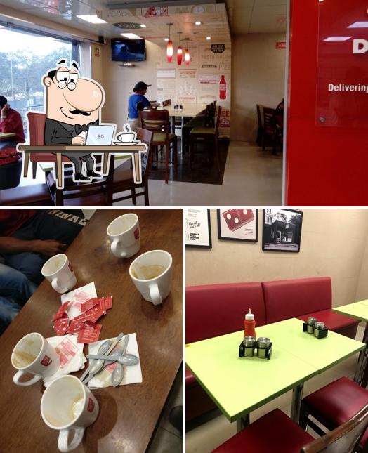 Take a seat at one of the tables at Domino's Pizza Srinagar, Kakinada