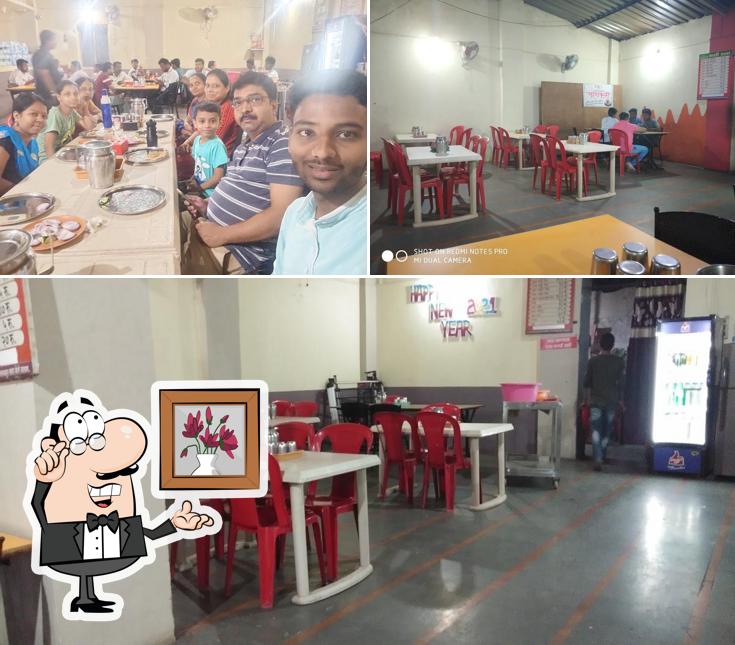 Check out the image depicting interior and dining table at Mali Dhaba