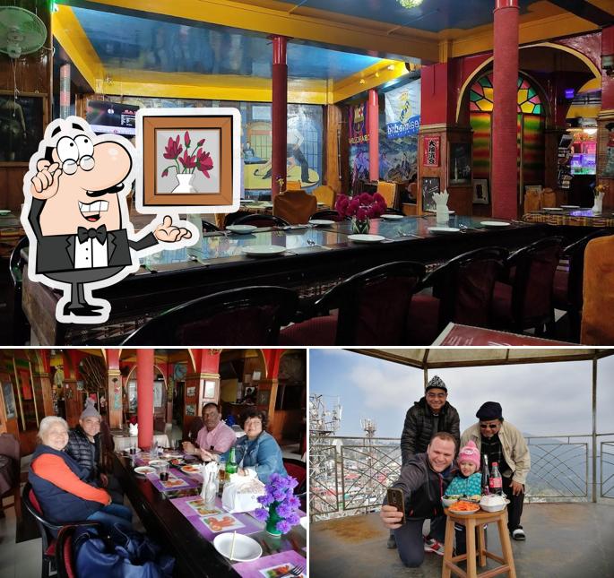 Take a seat at one of the tables at King Thai Hotel And Restaurant (SUPER MARKET)