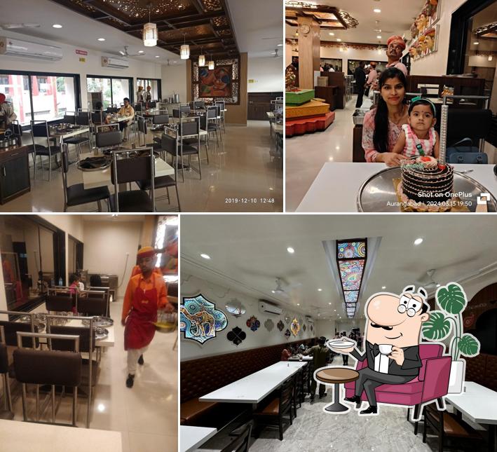 Take a seat at one of the tables at Bhoj Thali Restaurant