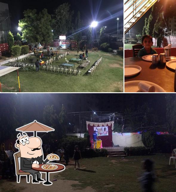 This is the image depicting exterior and dining table at Panghat Garden Restaurant