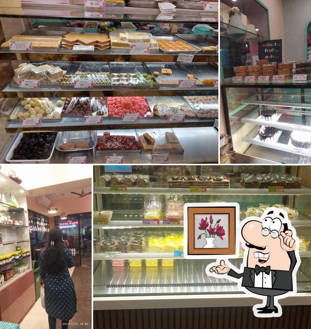 Take a seat at one of the tables at Archana Sweets Bakery & Cafe