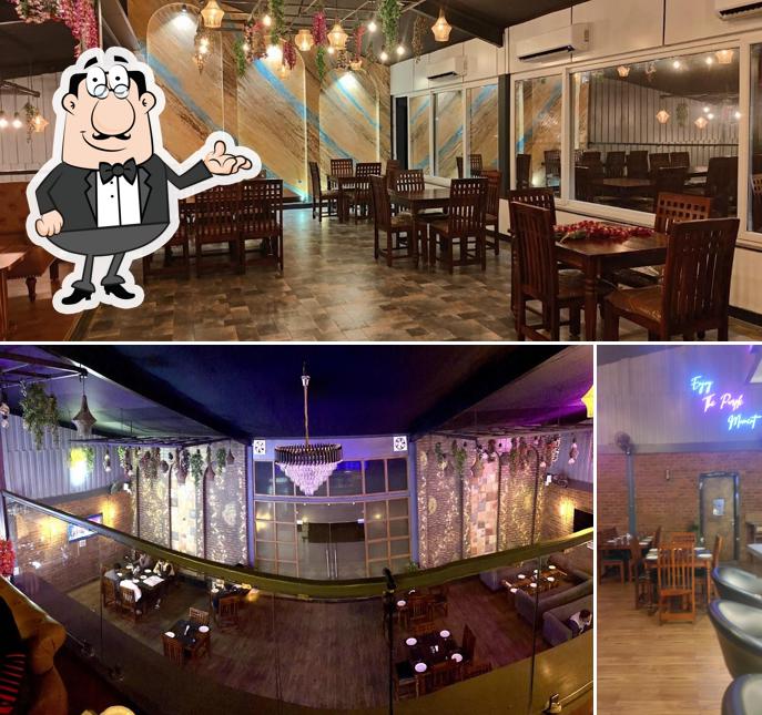 Take a seat at one of the tables at The Purple Lounge Bar & Restaurant