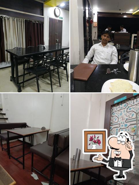 Take a seat at one of the tables at Hotel Veg Treat
