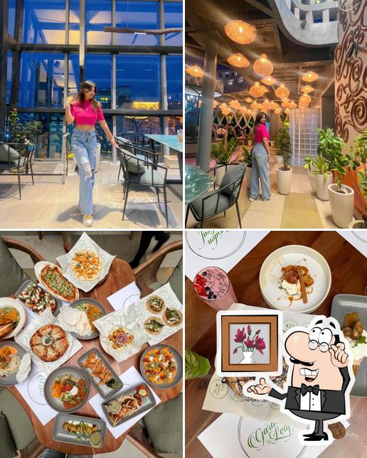 Take a seat at one of the tables at The Garden Leaf Pure Veg Cafe & Restaurant