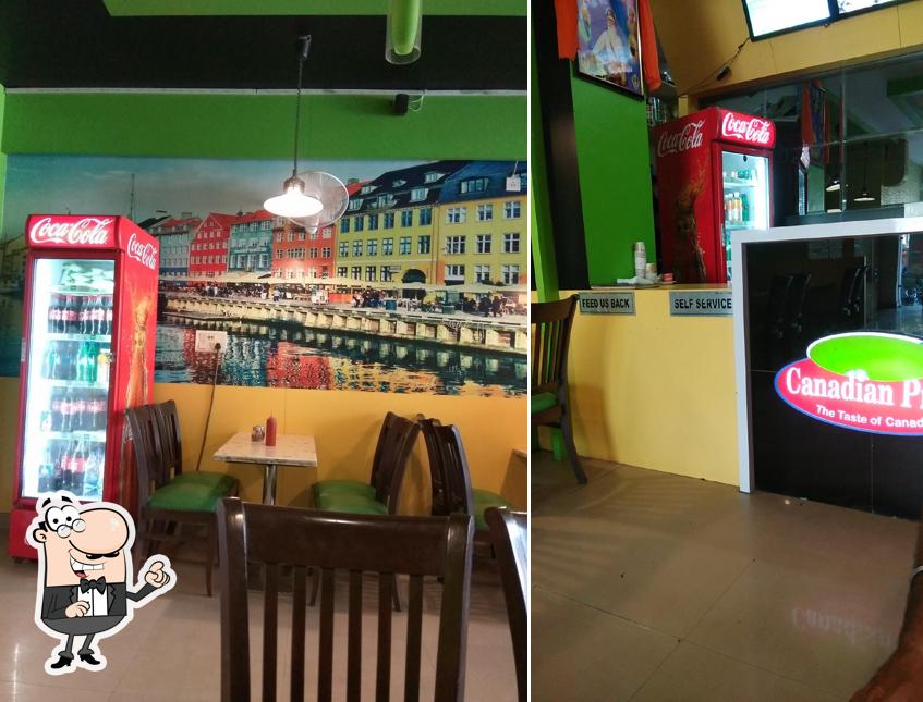 Take a seat at one of the tables at Canadian Pizza Tarn Taran