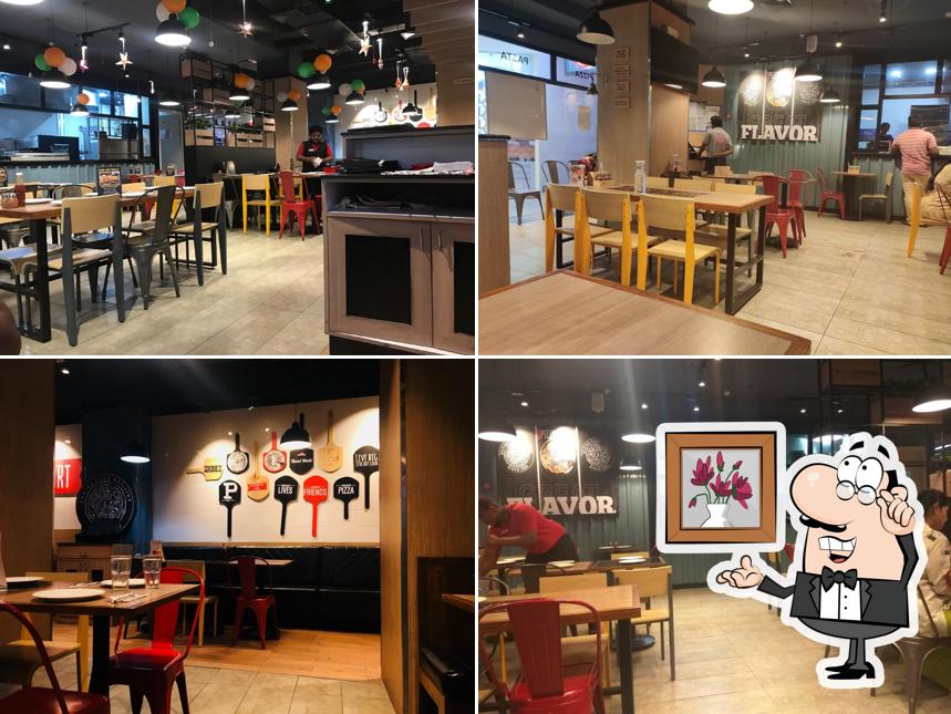 Take a seat at one of the tables at Pizza Hut PVP Mall, Vijayawada