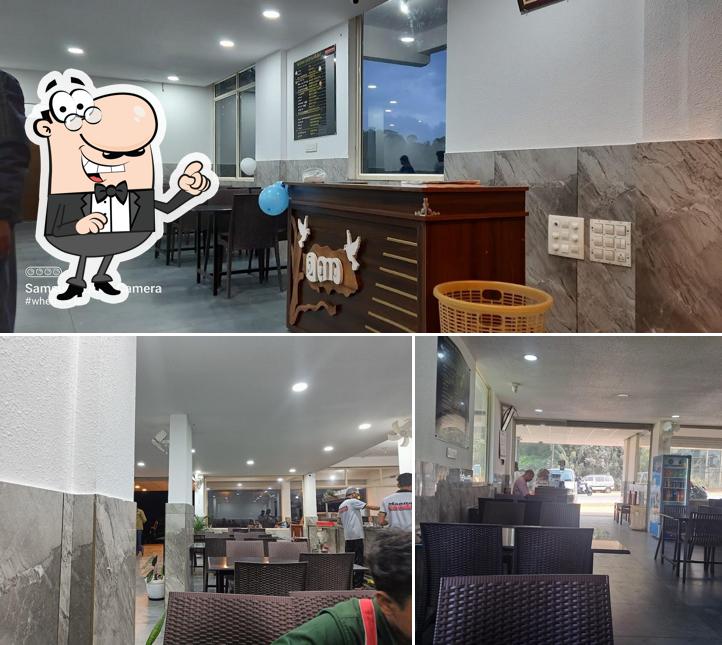 Take a seat at one of the tables at Manna Restaurant