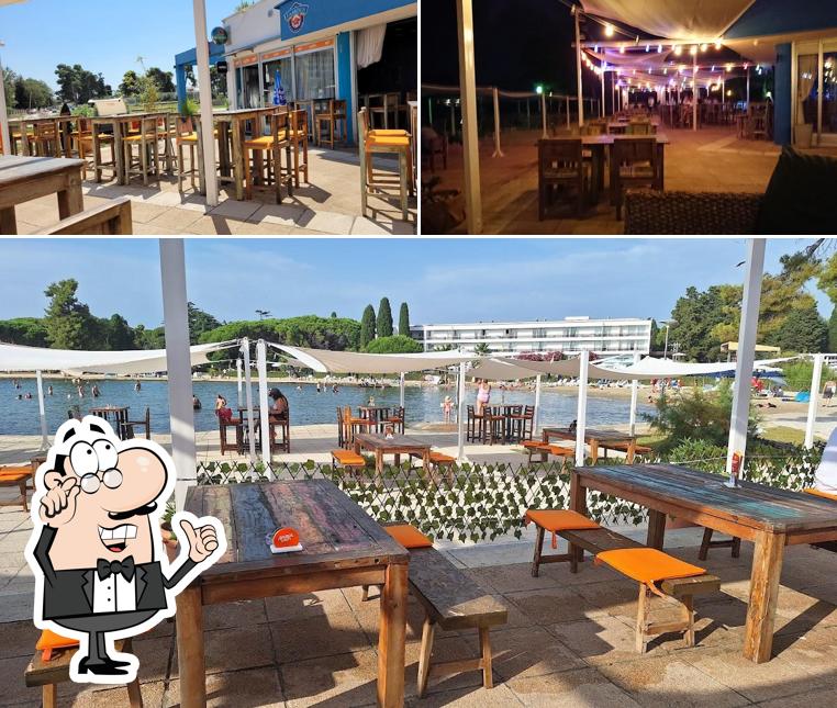 La immagine della interni e tavolo da pranzo di Famous Beach Bar & Grill