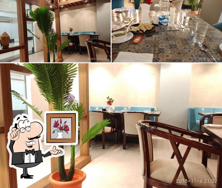 Take a seat at one of the tables at Raffles Restaurant