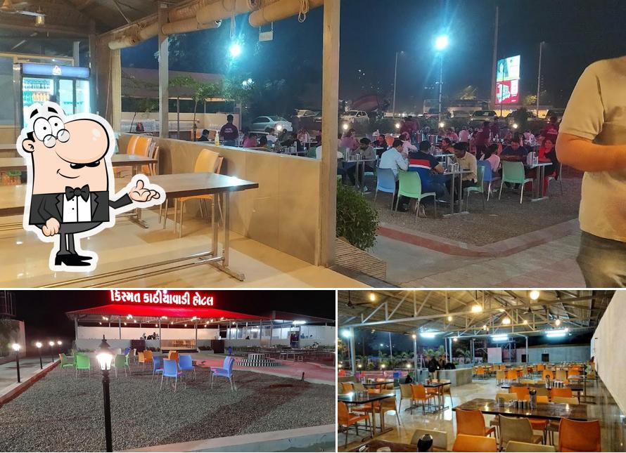 Take a seat at one of the tables at Kismat Kathiyavadi Hotel