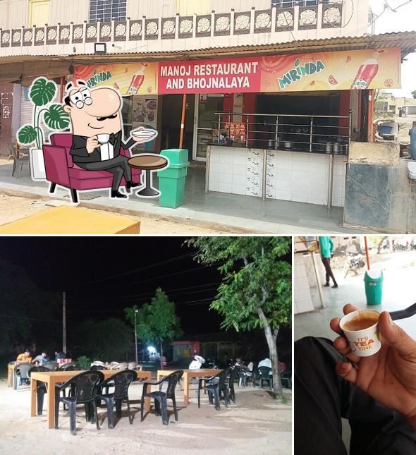 Take a seat at one of the tables at Manoj Restaurant