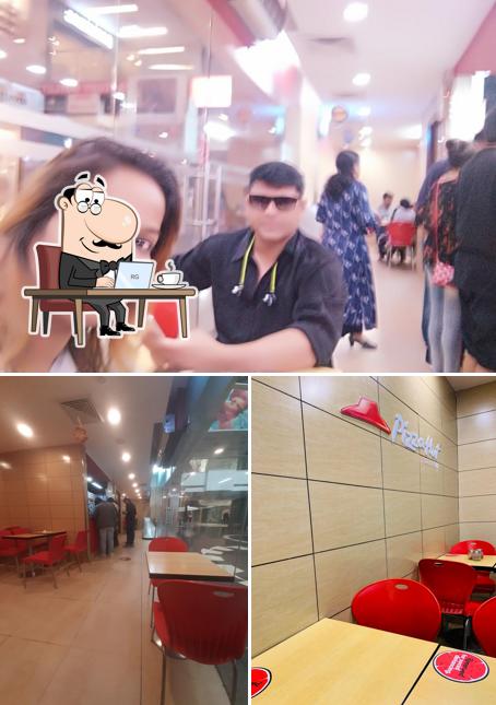 Take a seat at one of the tables at Pizza Hut Fun City Mall, Panipat