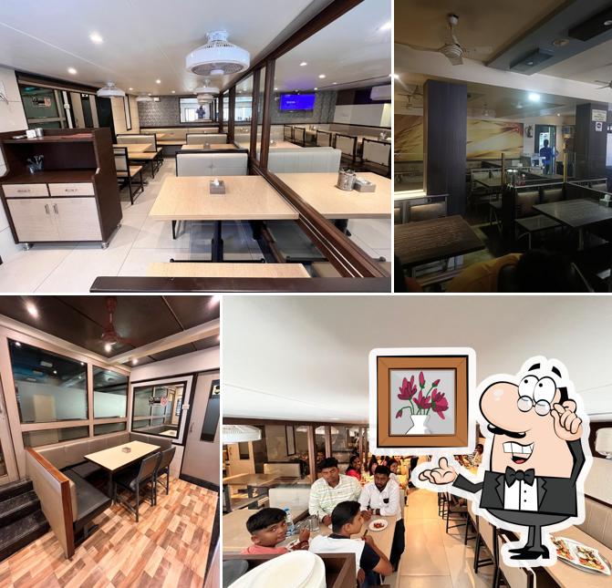 Take a seat at one of the tables at Pritam Bar & Restaurant