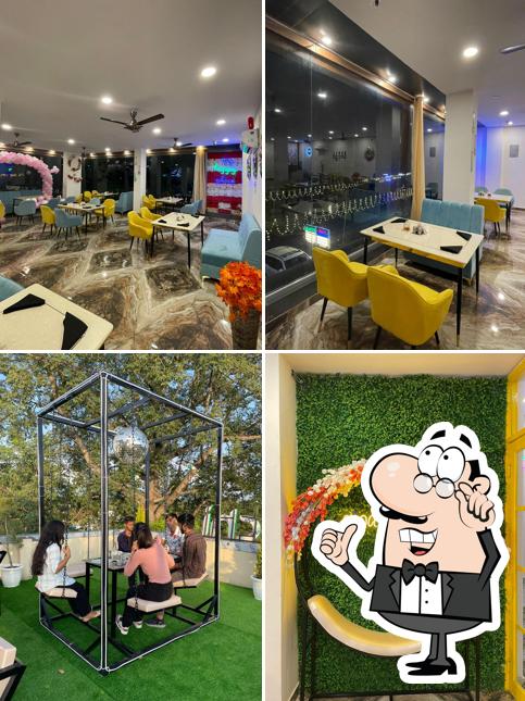 Take a seat at one of the tables at Elaichi Restaurant- Best and Only RoofTop Restaurant in vikasnagar