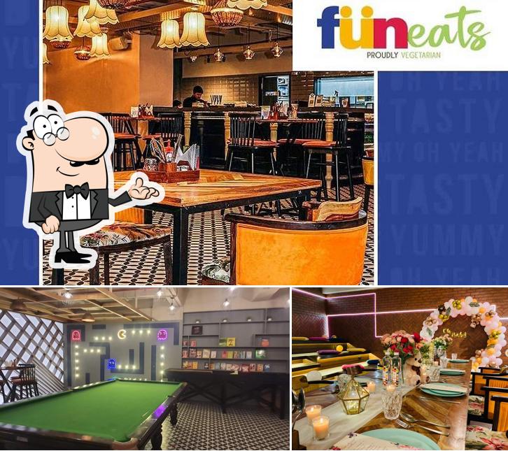 Take a look at the picture depicting interior and dining table at Funeats - Pure Veg Cafe & Restaurant Party Place