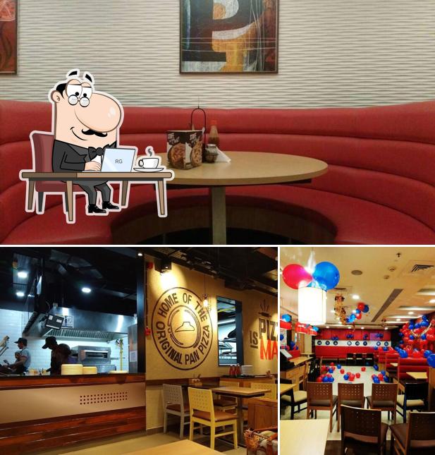 Take a seat at one of the tables at Pizza Hut Fun Republic Mall, Coimbatore