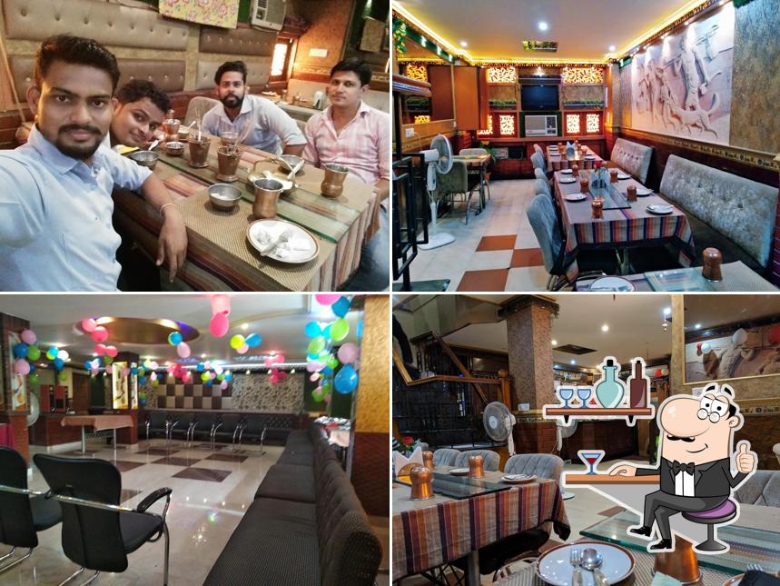 Take a seat at one of the tables at CHULA CHOWKA Restaurant