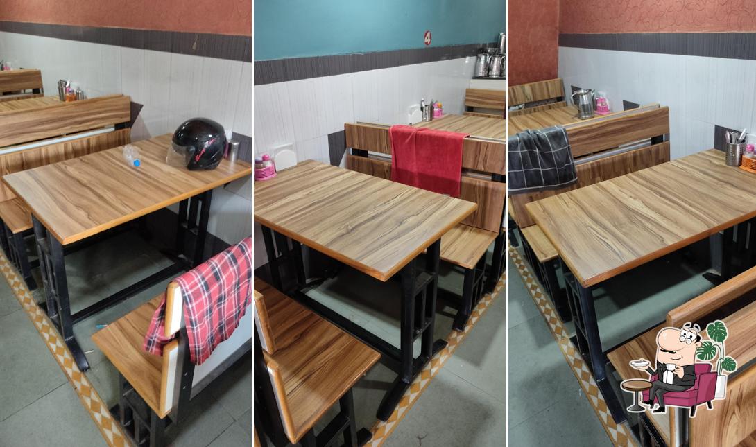 Take a seat at one of the tables at Gayatri Restaurant