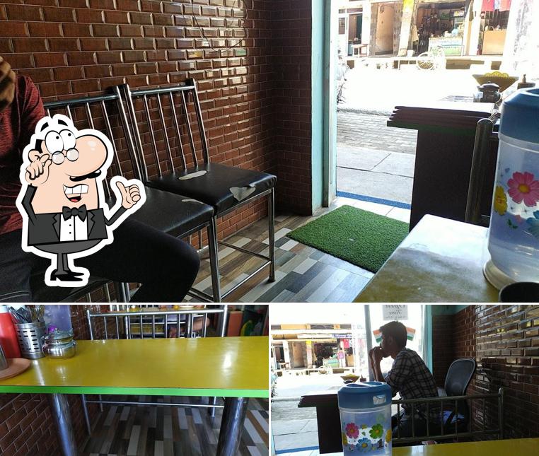 Take a seat at one of the tables at Rudra Fast Food Restaurant