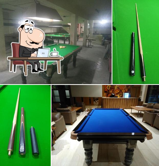 Take a seat at one of the tables at Ahmedabad Billiards & Snooker Coaching Academy and Manufacturing & Repairing
