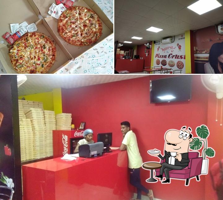 Take a look at the image depicting interior and pizza at Pizza Crust
