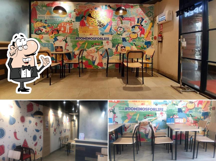 Take a seat at one of the tables at Domino's Pizza Zirakpur, Sahibzada Ajit Singh Nagar