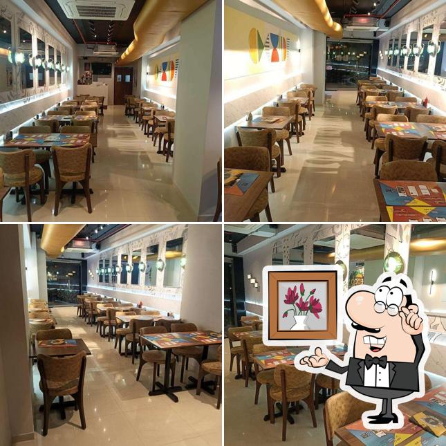 Take a seat at one of the tables at Choice Snack Bar Shela