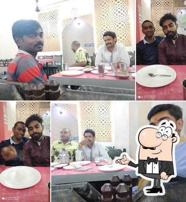 Take a seat at one of the tables at Hotel Vaishno Mahal