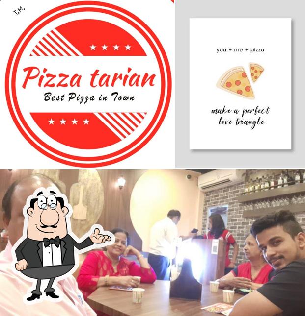 Take a seat at one of the tables at Pizzatarian (Best Pizza In Town)