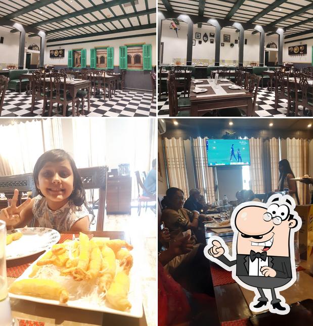 The picture of interior and dining table at Kabab Mahal