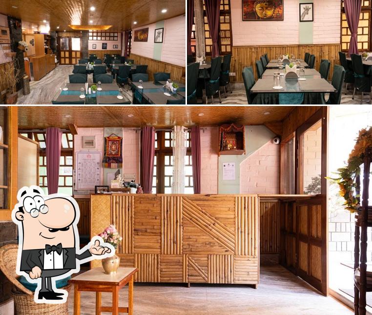 Take a seat at one of the tables at Hotel Bamboo Inn a unit of Ravongla Star Vacations and Hospitality