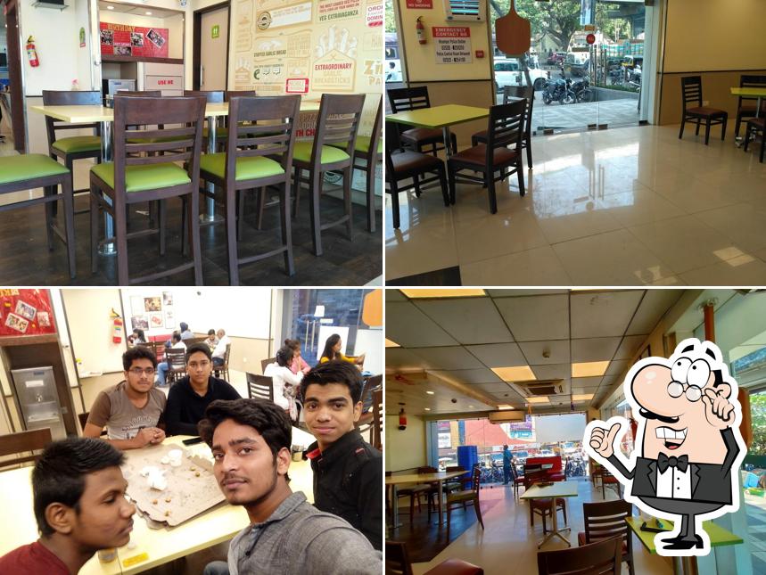 Take a seat at one of the tables at Domino's Pizza Nehru Nagar, Bhiwandi