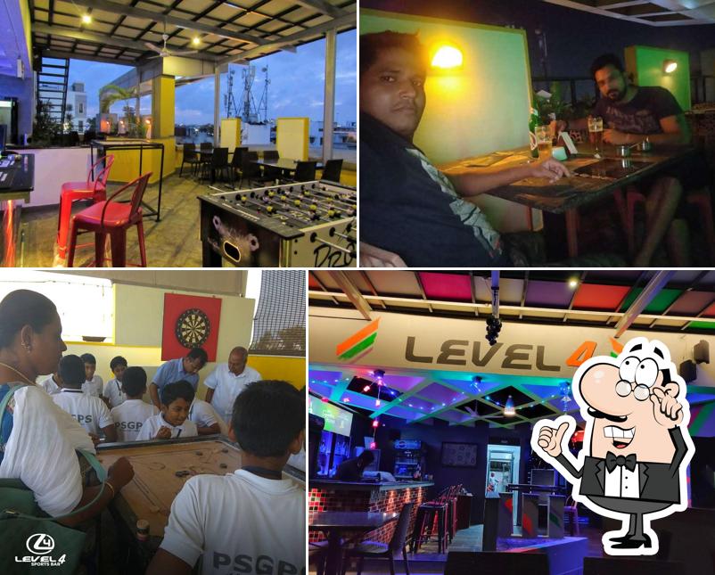 Take a seat at one of the tables at Level 4 Sports Bar Rooftop Pub Best Pub in Pondicherry