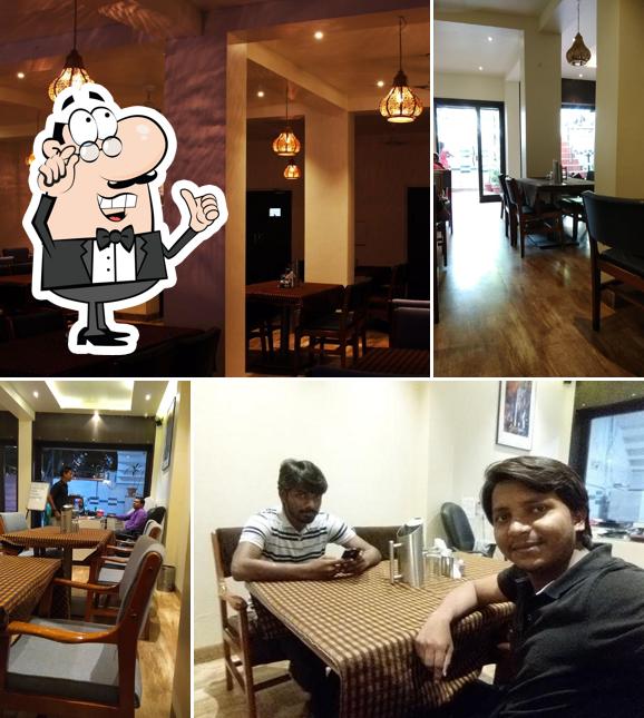 Take a seat at one of the tables at Dawat restaurant