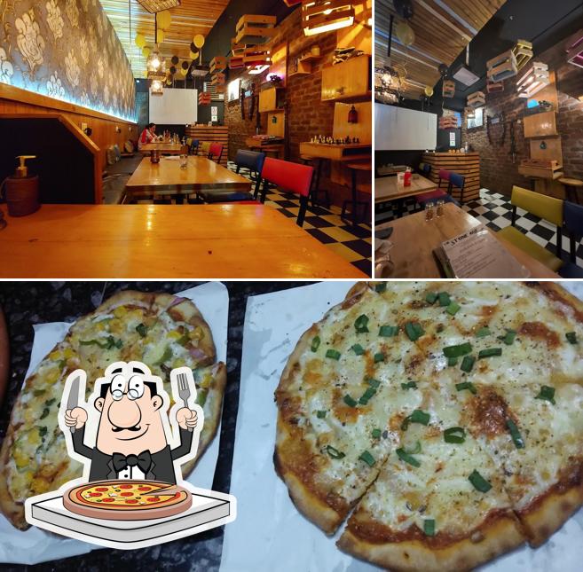 Get pizza at The Stone Age Cafe