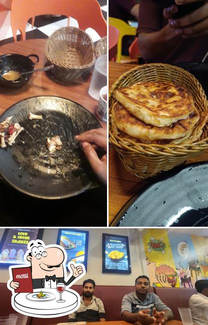Check out the photo depicting food and interior at The Porotta Master