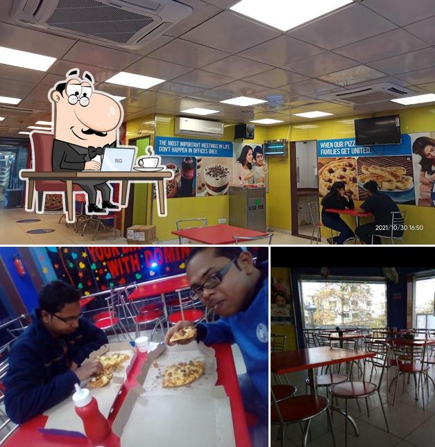 Take a seat at one of the tables at Domino's Pizza LIC Colony, Cuttack