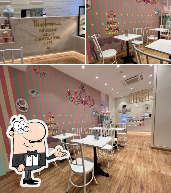 Take a seat at one of the tables at Theobroma Bakery and Cake Shop - Ghod Dod Road, Surat