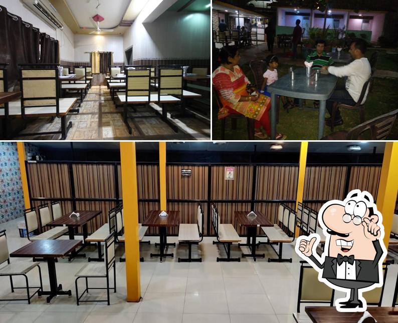 Take a seat at one of the tables at Hotel Sahyadri family gardan restaurant and bar