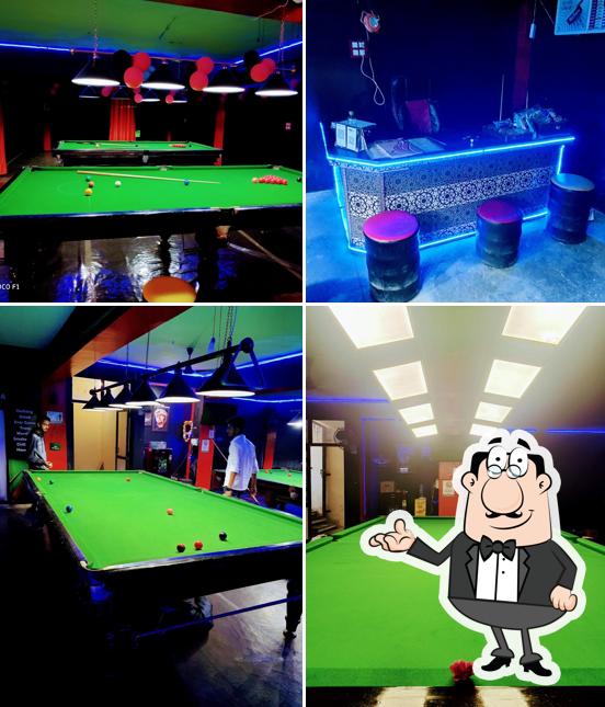 Take a seat at one of the tables at CUE CAN DO SNOOKER CLUB AND CAFE